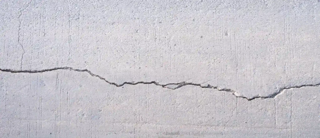 Concrete surface with a horizontal crack, indicating the need for foundation sealer