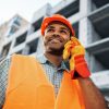 young-construction-worker-in-uniform-using-walkie-2021-09-29-23-12-25-utc